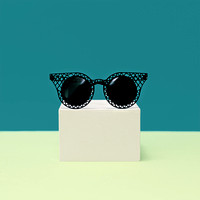 Black stylish Sunglasses on bright background. Minimalism fashio