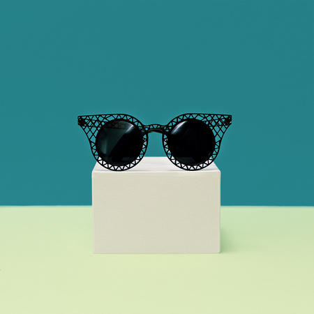 Black stylish Sunglasses on bright background. Minimalism fashio